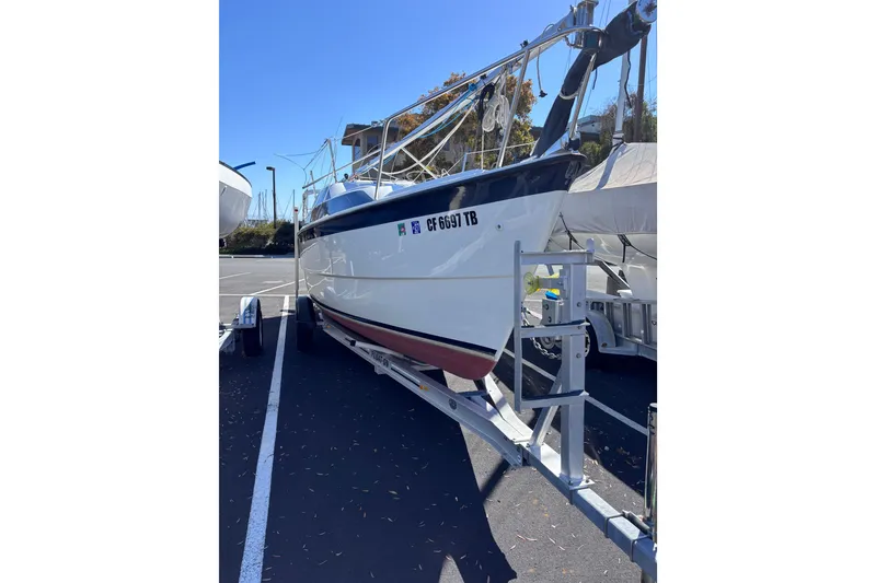 Slide: The Image of 2014 Tattoo 26 sailboat on trailer in parking lot, ready for transport. - 1