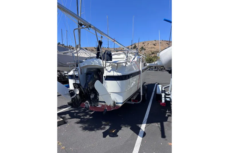 Slide: The Image of 2014 Tattoo 26 sailboat on trailer in sunny parking lot. - 2