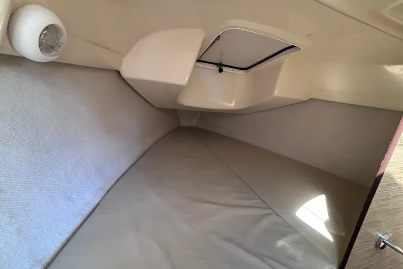 Slide: The Image of Cozy interior cabin of a 2014 Tattoo 26 sailboat, featuring a comfortable sleeping area. - 11
