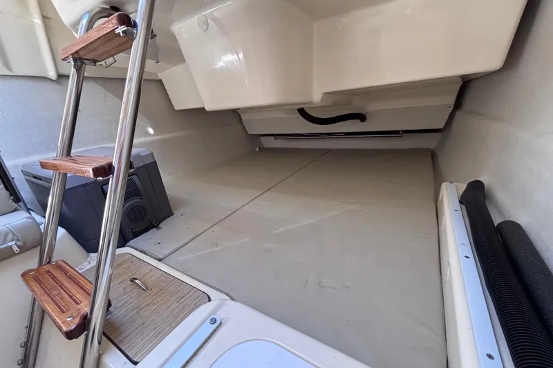 Slide: The Image of Interior view of a 2014 Tattoo 26 sailboat cabin with wooden ladder steps. - 10