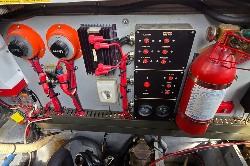 Slide: The Image of Control panel of a 1990 Sea Ray Sundancer 350 with wiring and fire extinguisher. - 33