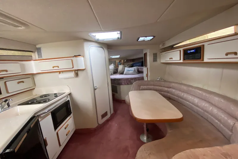 Slide: The Image of Interior of a 1990 Sea Ray Sundancer 350 yacht with kitchen and seating area. - 19