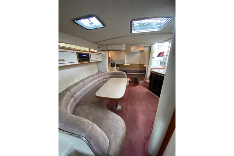 Slide: The Image of Interior of 1990 Sea Ray Sundancer 350 yacht with plush seating and dining area. - 17