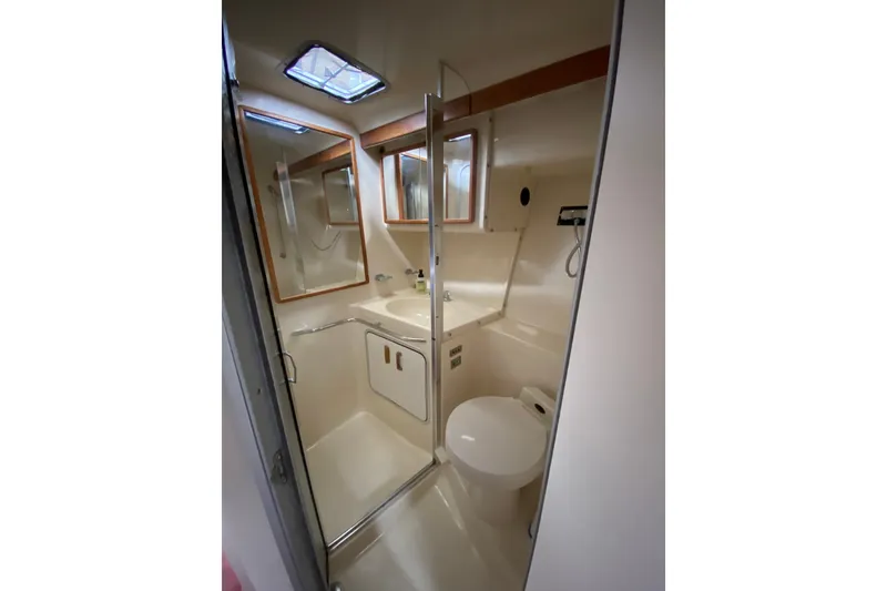 Slide: The Image of Bathroom interior of 1990 Sea Ray Sundancer 350 yacht, featuring shower and toilet. - 22