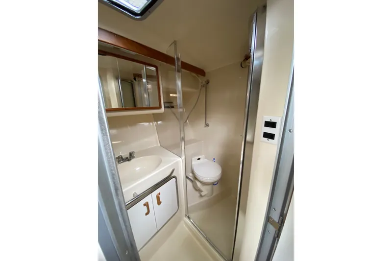 Slide: The Image of Bathroom interior of 1990 Sea Ray Sundancer 350 yacht, featuring sink, toilet, and shower. - 23