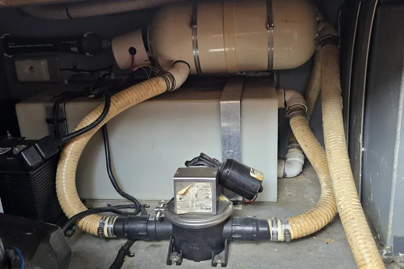 Slide: The Image of Engine compartment of a 1990 Sea Ray Sundancer 350 with hoses and equipment. - 24