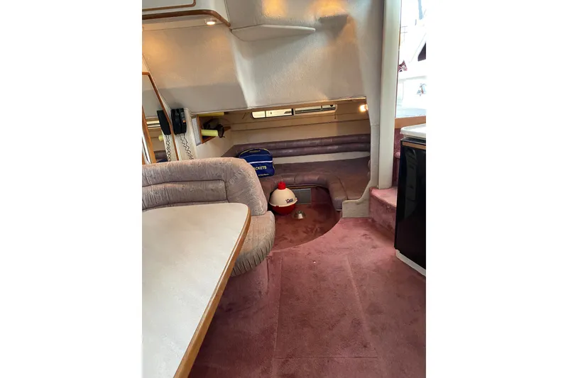 Slide: The Image of Interior of 1990 Sea Ray Sundancer 350 with plush seating and carpeted flooring. - 18