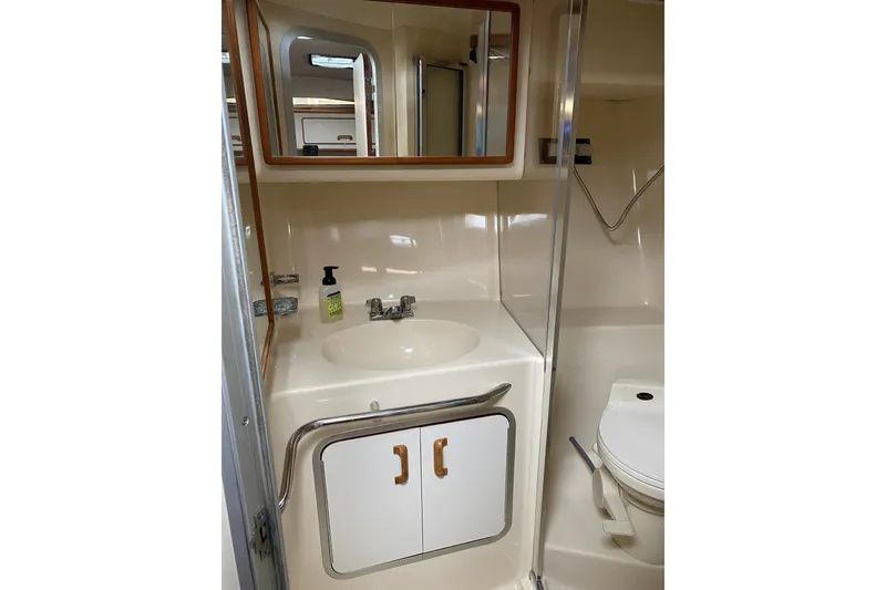 Slide: The Image of Bathroom interior of 1990 Sea Ray Sundancer 350 yacht, featuring sink and toilet. - 21