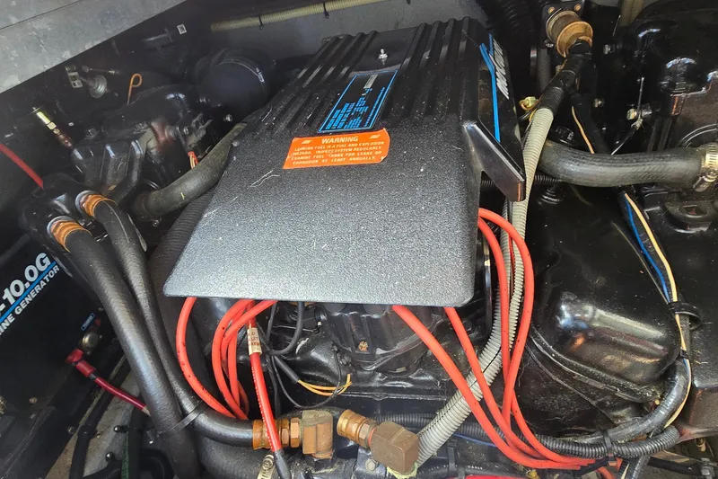 Slide: The Image of Engine compartment of a 1990 Sea Ray Sundancer 350 with visible wiring and components. - 29