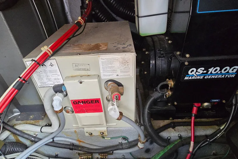 Slide: The Image of Engine room of 1990 Sea Ray Sundancer 350 with marine generator and electrical components. - 31