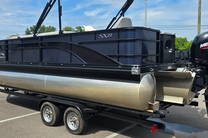 Slide: The Image of 2022 Bennington SX 22 Fishing pontoon boat on trailer, parked outdoors. - 4