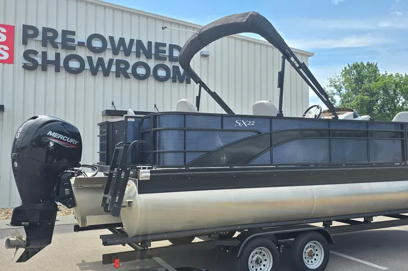 Slide: The Image of 2022 Bennington SX 22 Fishing boat at pre-owned showroom, featuring Mercury engine. - 1