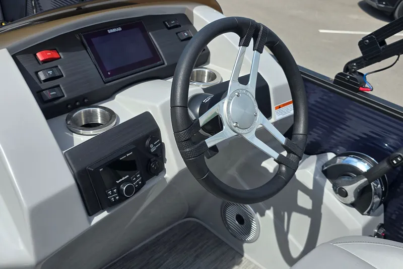 Slide: The Image of 2022 Bennington SX 22 Fishing boat dashboard with steering wheel and controls. - 11