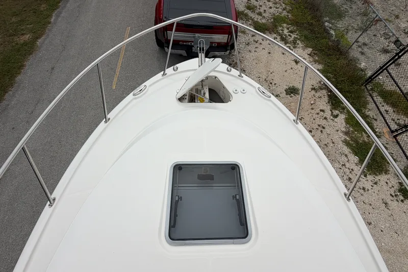 Slide: The Image of 2014 Robalo R305 Walkaround boat bow view with hatch and railing. - 42