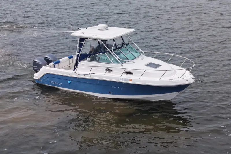 Slide: The Image of 2014 Robalo R305 Walkaround boat cruising on open water. - 18