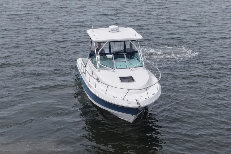 Slide: The Image of 2014 Robalo R305 Walkaround boat cruising on open water. - 17