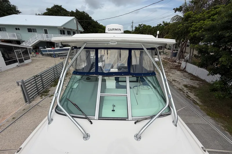 Slide: The Image of 2014 Robalo R305 Walkaround boat with Garmin equipment, docked near residential area. - 44