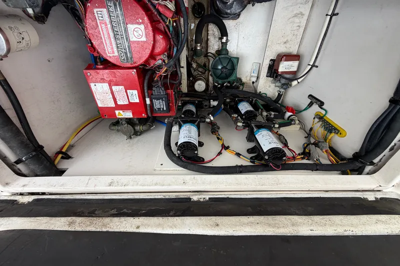 Slide: The Image of Engine compartment of a 2014 Robalo R305 Walkaround boat, showcasing mechanical components. - 37