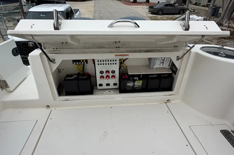 Slide: The Image of 2014 Robalo R305 Walkaround boat battery compartment with electrical panel and storage. - 27