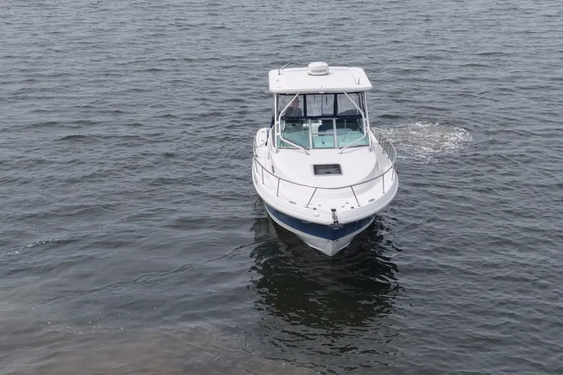 Slide: The Image of 2014 Robalo R305 Walkaround boat cruising on open water. - 16