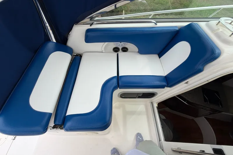 Slide: The Image of 2014 Robalo R305 Walkaround boat interior with blue and white cushioned seating. - 35