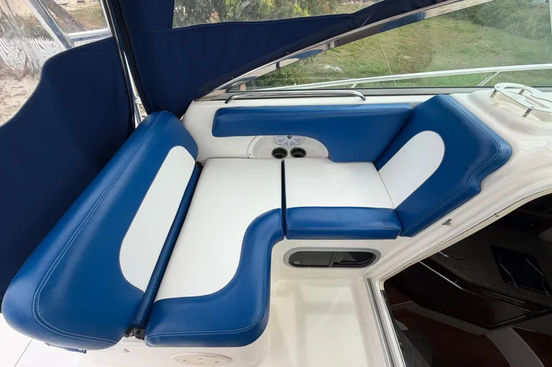 Slide: The Image of 2014 Robalo R305 Walkaround boat interior with blue and white cushioned seating. - 34