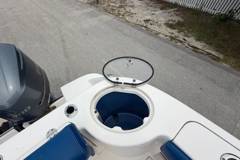 Slide: The Image of 2014 Robalo R305 Walkaround boat with open storage compartment and Yamaha engine. - 41