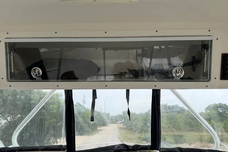 Slide: The Image of 2014 Robalo R305 Walkaround boat interior with windshield and storage compartment. - 30