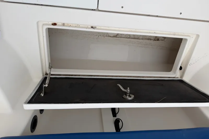 Slide: The Image of Open storage compartment on a 2014 Robalo R305 Walkaround boat. - 38