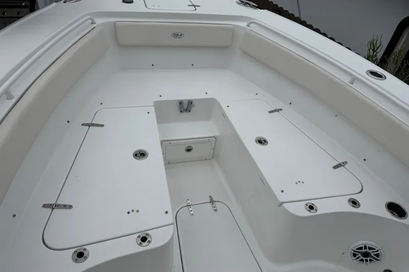 Slide: The Image of 2026 Sea Hunt Ultra 265SE boat interior with spacious seating and storage compartments. - 13