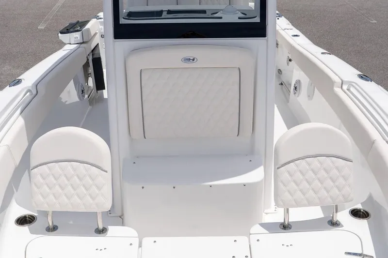 Slide: The Image of 2026 Sea Hunt Ultra 265SE boat interior with white cushioned seating and sleek design. - 15