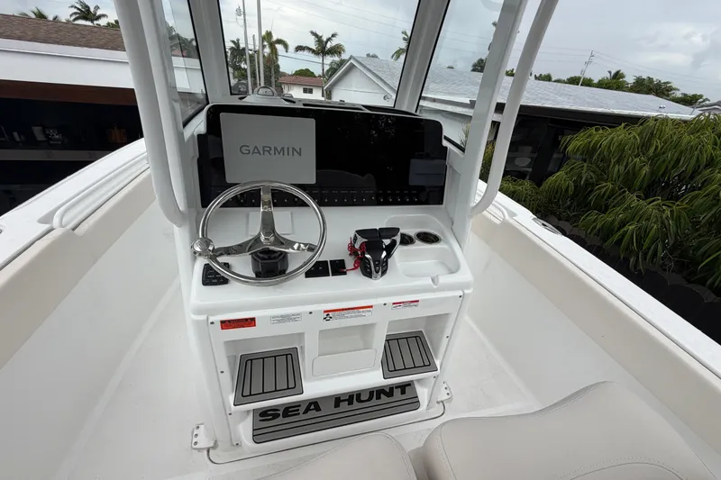 Slide: The Image of 2026 Sea Hunt Ultra 265SE boat console with Garmin navigation system and steering wheel. - 11