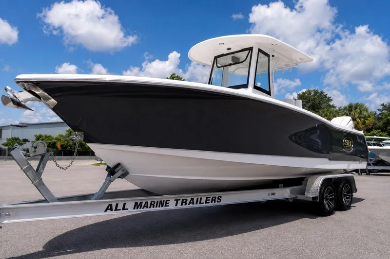 The Image of 2026 Sea Hunt Ultra 265SE boat on trailer under blue sky. - 0