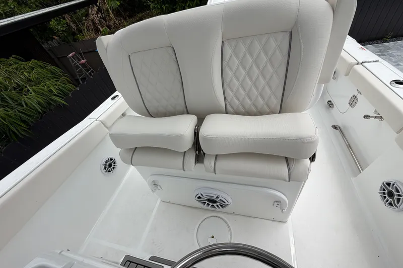 Slide: The Image of Luxurious seating on 2026 Sea Hunt Ultra 265SE boat, featuring elegant white upholstery. - 10
