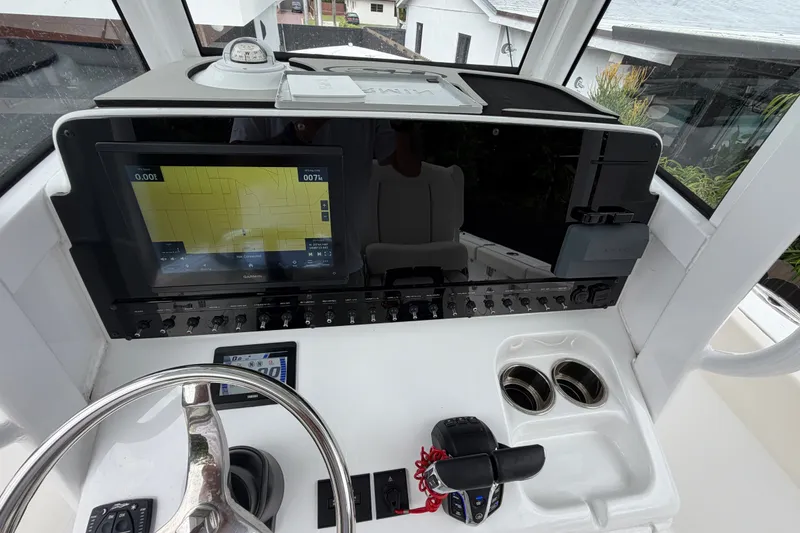 Slide: The Image of Helm of 2026 Sea Hunt Ultra 265SE with navigation display and controls. - 9