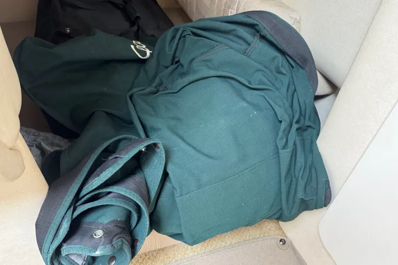 Slide: The Image of Green fabric bundle inside a 2002 Sea Ray Sundancer 260 boat interior. - 24
