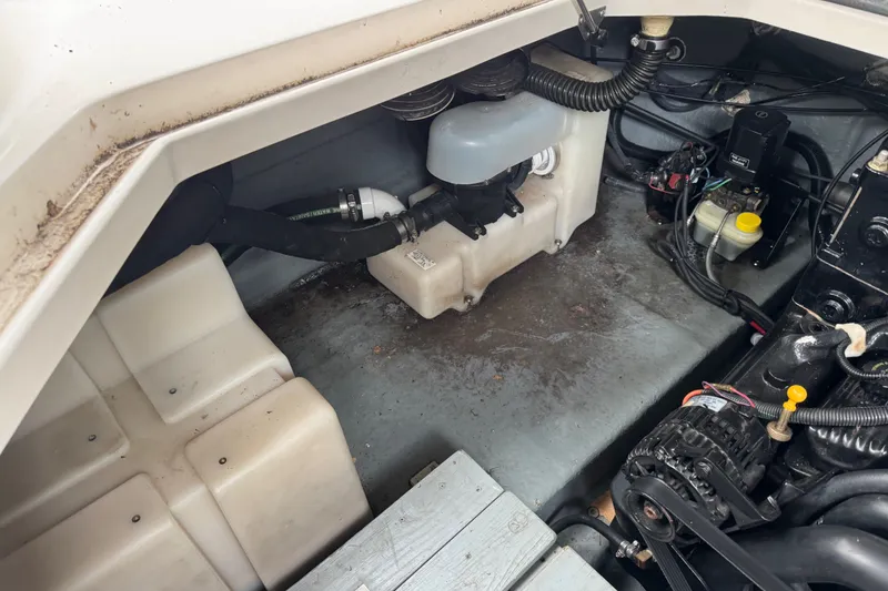 Slide: The Image of Engine compartment of a 2002 Sea Ray Sundancer 260, showcasing mechanical components and wiring. - 15