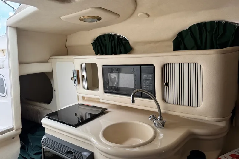 Slide: The Image of Interior of 2002 Sea Ray Sundancer 260 boat with kitchenette and microwave. - 21