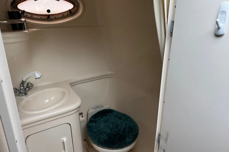 Slide: The Image of Bathroom interior of 2002 Sea Ray Sundancer 260 boat with sink and toilet. - 27