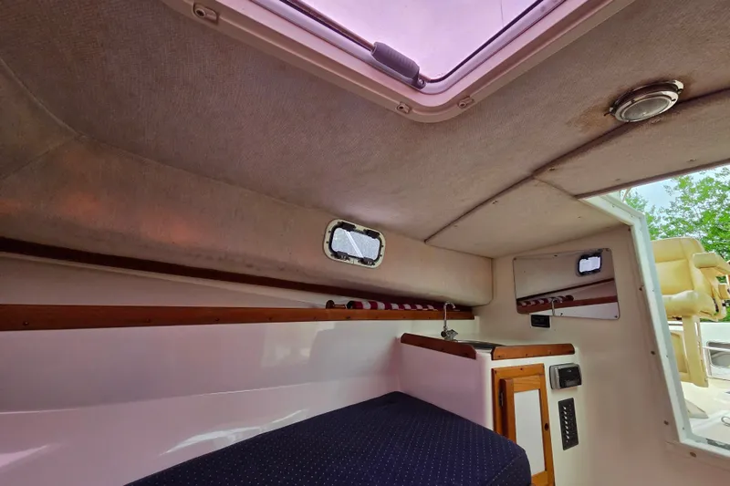 Slide: The Image of Interior cabin of 2004 Hunt Yachts Surfhunter 25, featuring seating and storage. - 22