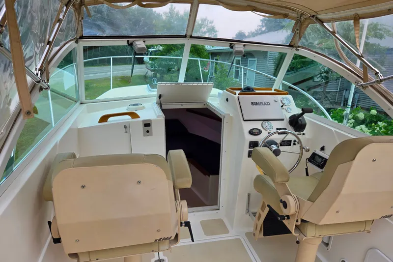 Slide: The Image of 2004 Hunt Yachts Surfhunter 25 cockpit with dual seats and navigation equipment. - 14