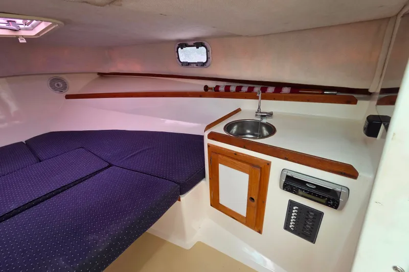 Slide: The Image of Interior of 2004 Hunt Yachts Surfhunter 25 with cozy cabin and compact kitchenette. - 29