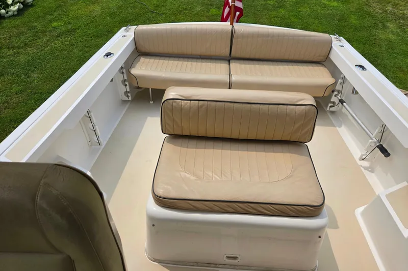 Slide: The Image of 2004 Hunt Yachts Surfhunter 25 interior with beige seating and American flag. - 16