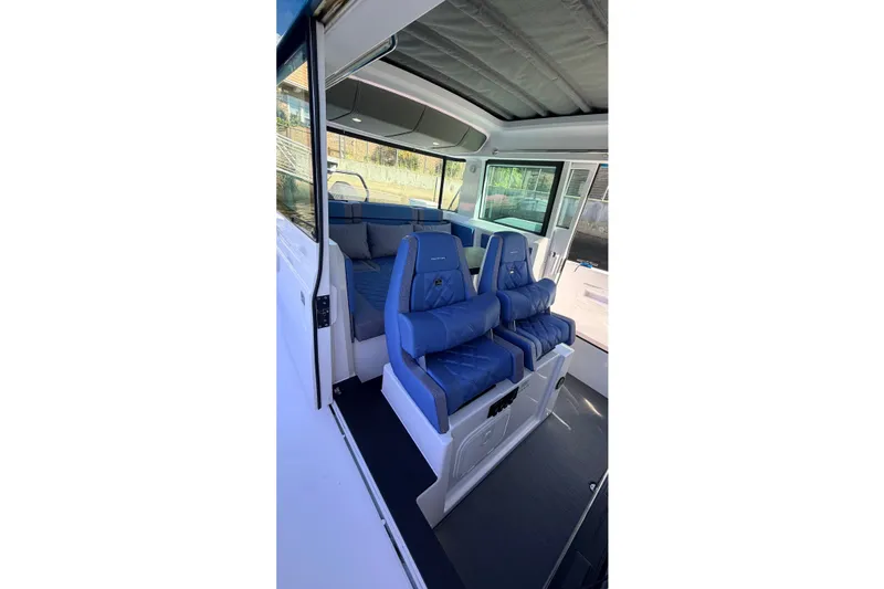 Slide: The Image of 2024 Axopar 37 XC Cross Cabin interior with blue seating and modern design. - 21