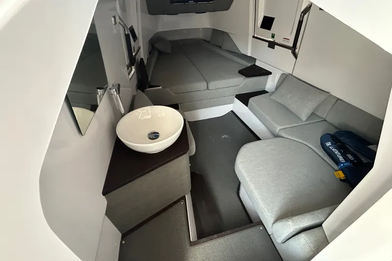 Slide: The Image of 2024 Axopar 37 XC Cross Cabin interior with modern seating and compact sink. - 5