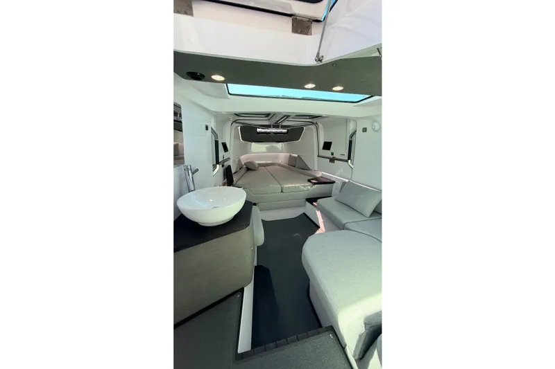 Slide: The Image of 2024 Axopar 37 XC Cross Cabin interior with modern seating and skylight. - 28