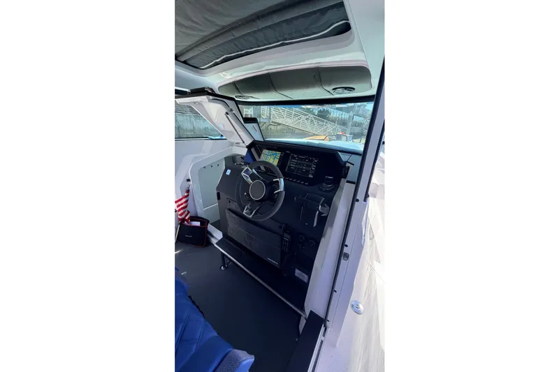 Slide: The Image of 2024 Axopar 37 XC Cross Cabin helm with modern controls and navigation system. - 25