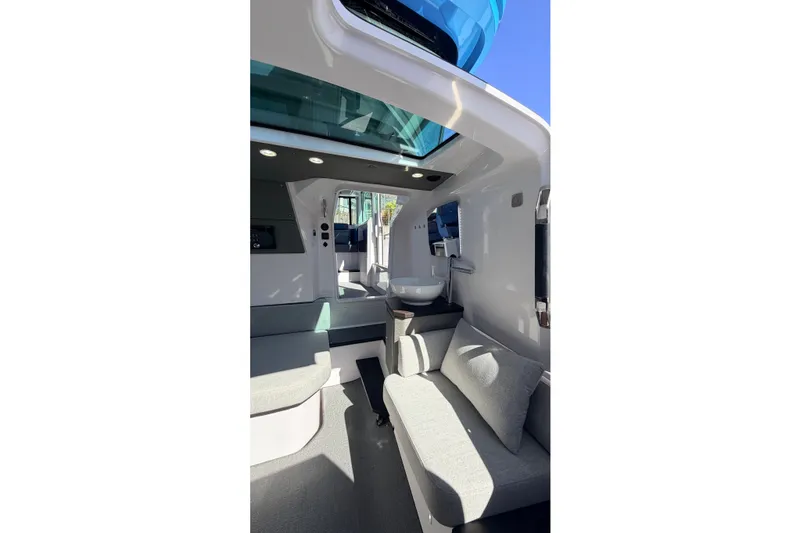 Slide: The Image of Interior of 2024 Axopar 37 XC Cross Cabin, featuring modern seating and skylight. - 31