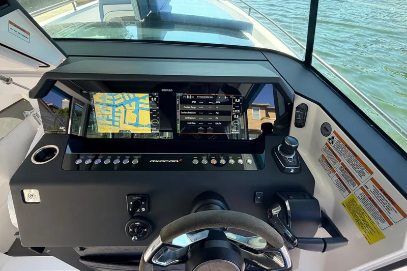 Slide: The Image of 2024 Axopar 37 XC Cross Cabin dashboard with navigation and control systems. - 19