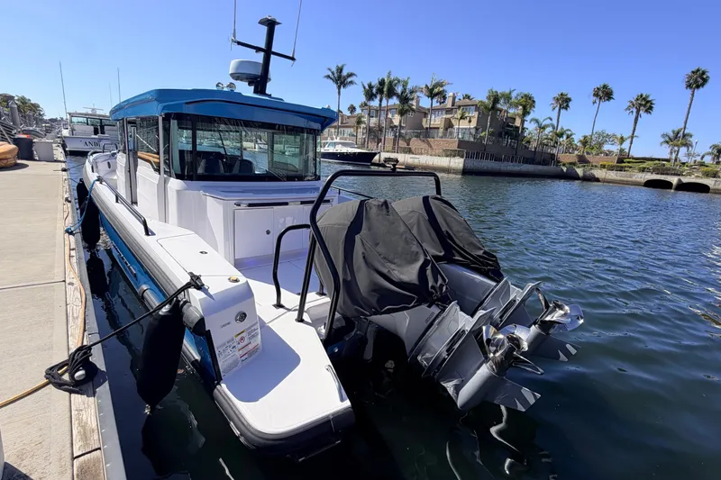 Slide: The Image of 2024 Axopar 37 XC Cross Cabin docked in a sunny marina setting. - 17